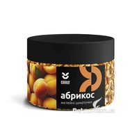 Банка желейных кусочков Cookit Абрикос с чёрной крышкой, светло-оранжевые кубики видны через стенку